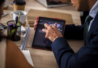 high-angle-employees-using-tablet